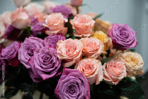 Bouquet of flowers from roses of different colors. Pink and purple roses.