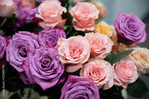 Bouquet of flowers from roses of different colors. Pink and purple roses.
