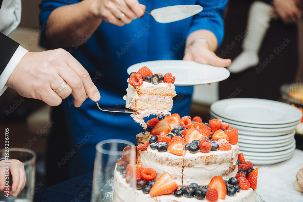 Festive cake with white cream, decorated with raspberries and strawberries