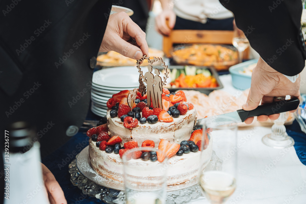 Festive cake with white cream, decorated with raspberries and strawberries