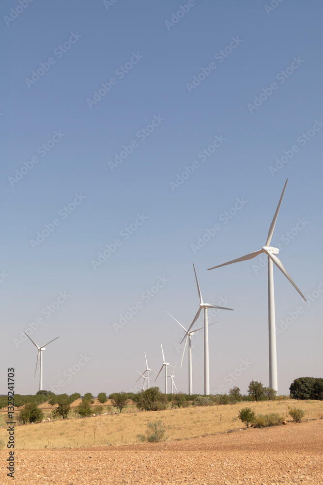 row of windmills in crop fields row of windmills in crop fields
