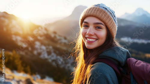 Happy young woman with backpack hiking in mountains