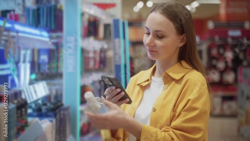 A person scans various micellar water products on the shelf while shopping at a retail store. The atmosphere is bright, showcasing numerous beauty items displayed for selection.