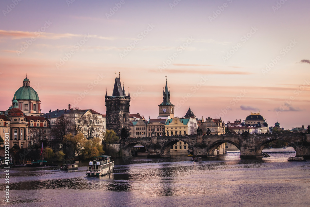 Prague, Czechia - 02 November 2022: View of Charles Bridge and Old Town Tower at sunset with a picturesque skyline, Prague, Bohemia, Czechia. Prague, Czechia - 02 November 2022: View of Charles Bridge and Old Town Tower at sunset with a picturesque skyline, Prague, Bohemia, Czechia.