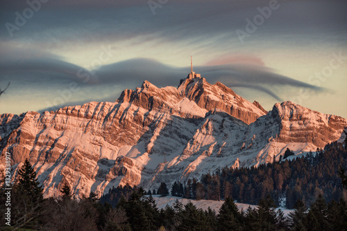 View of majestic Santis mountain at sunset surrounded by snow and clouds, Schwantlen, Thurgau, Switzerland. photo