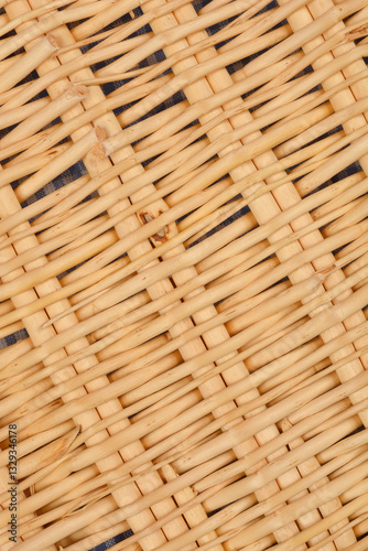 A close-up shot of woven rattan with a visible underlying fabric, creating a textured pattern