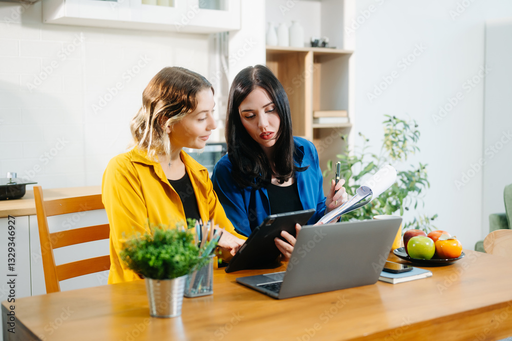 Caucasian Teamwork and creativity with sitting working at kitchen table young collaborating. Caucasian Teamwork and creativity with sitting working at kitchen table young collaborating.