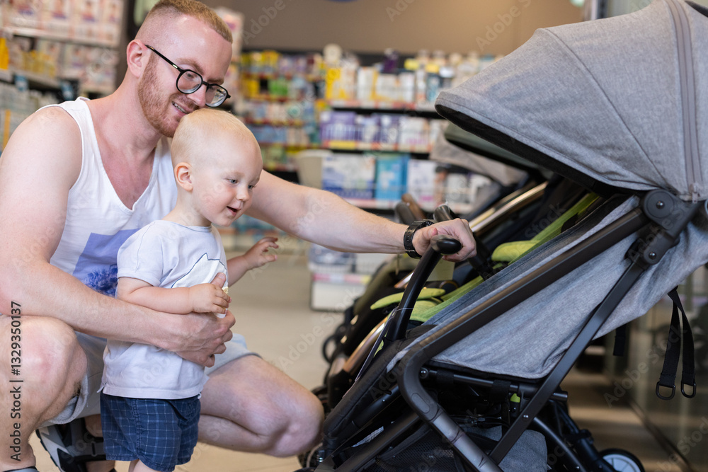 Obraz premium Happy little kid together with his father choosing a baby troller in a children shop. 