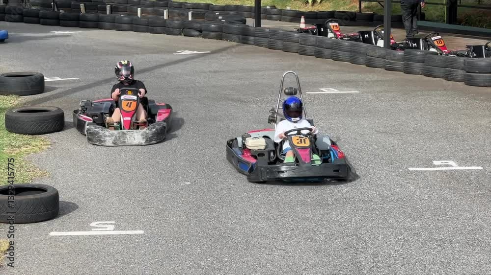 Slow motion of men driving go kart on the track