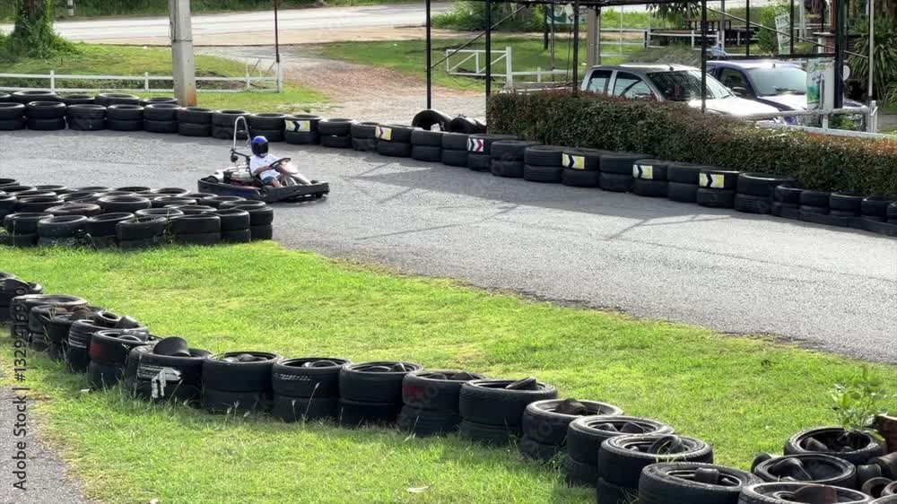 Slow motion of men driving go kart on the track