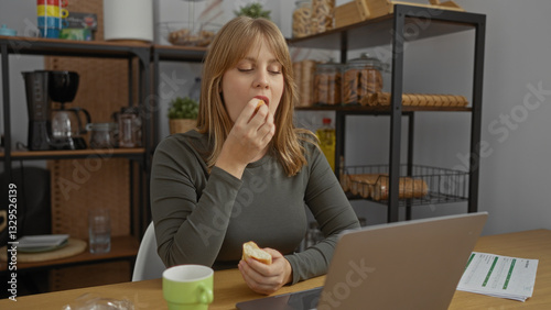 Woman enjoying snack in office setting with computer, surrounded by shelves of snacks, portraying a relaxed atmosphere ideal for work breaks and stress relief.