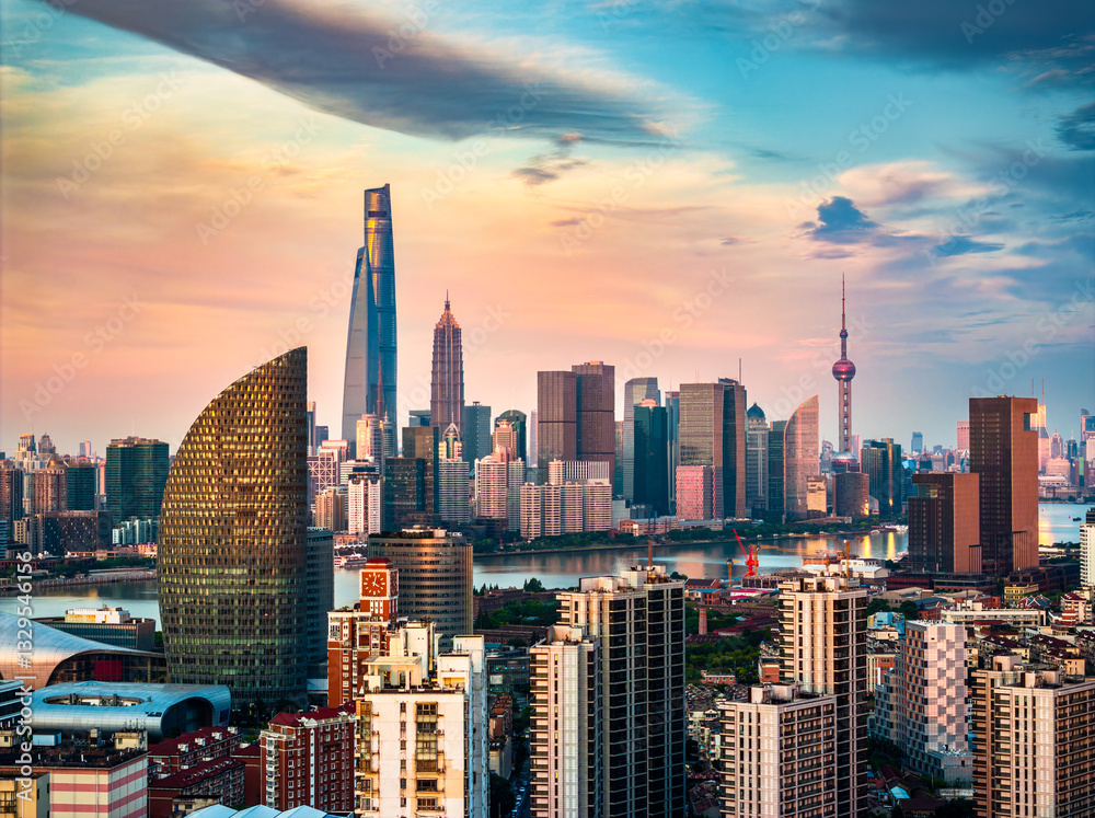 Obraz premium Shanghai skyline with modern skyscrapers and dramatic sky at sunset