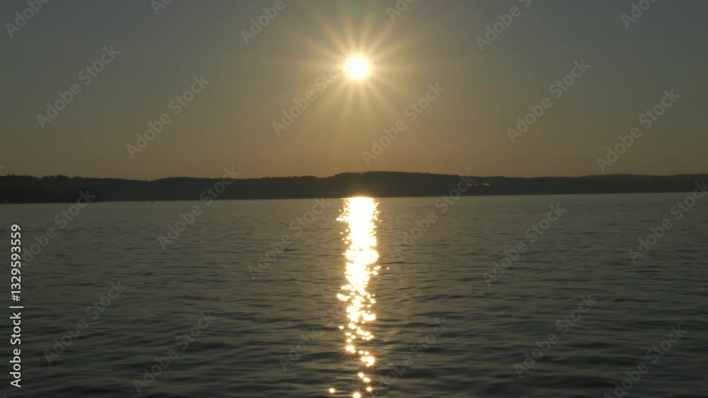 Golden Sunset Over a Calm Lake with Sunlight Reflection on Water Golden Sunset Over a Calm Lake with Sunlight Reflection on Water