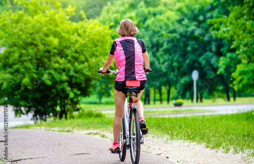 Wallpaper Mural Cyclist ride on the bike path in the city Park
 Torontodigital.ca