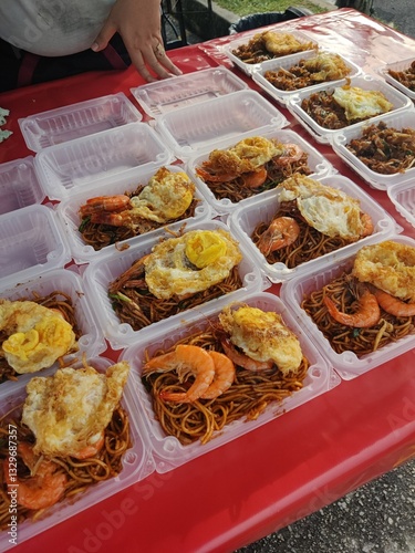 Vendor selling cuisine at street bazaar in Malaysia catered for iftar during Muslim fasting month of Ramadan