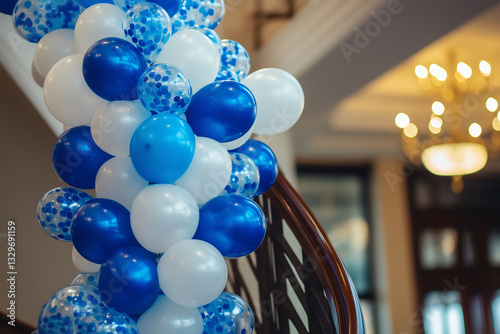 Elegant Balloon Decoration. Blue and white balloons decorate an elegant staircase, perfect for festive events or celebrations indoors.