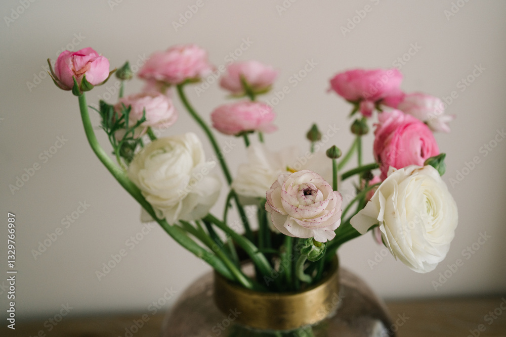 Bouquet of pink and white ranunculus flowers in a glass vase Bouquet of pink and white ranunculus flowers in a glass vase