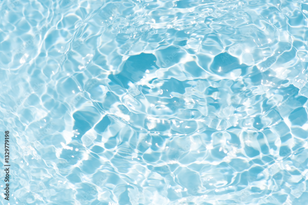 Obraz premium Blue water with ripples on the surface. Defocus blurred transparent blue colored clear calm water surface texture with splashes and bubbles. Water waves with shining pattern texture background.