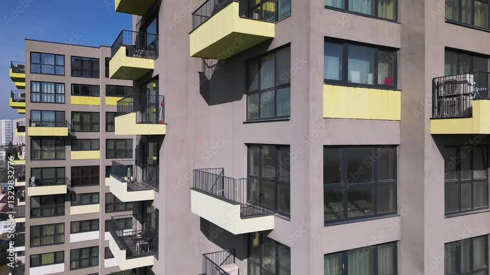 Aerial drone view of colorful residential buildings with unique architectural facades, showcasing modern urban design and city living in a vibrant cityscape