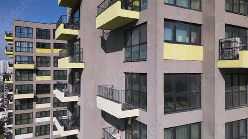 Aerial drone view of colorful residential buildings with unique architectural facades, showcasing modern urban design and city living in a vibrant cityscape