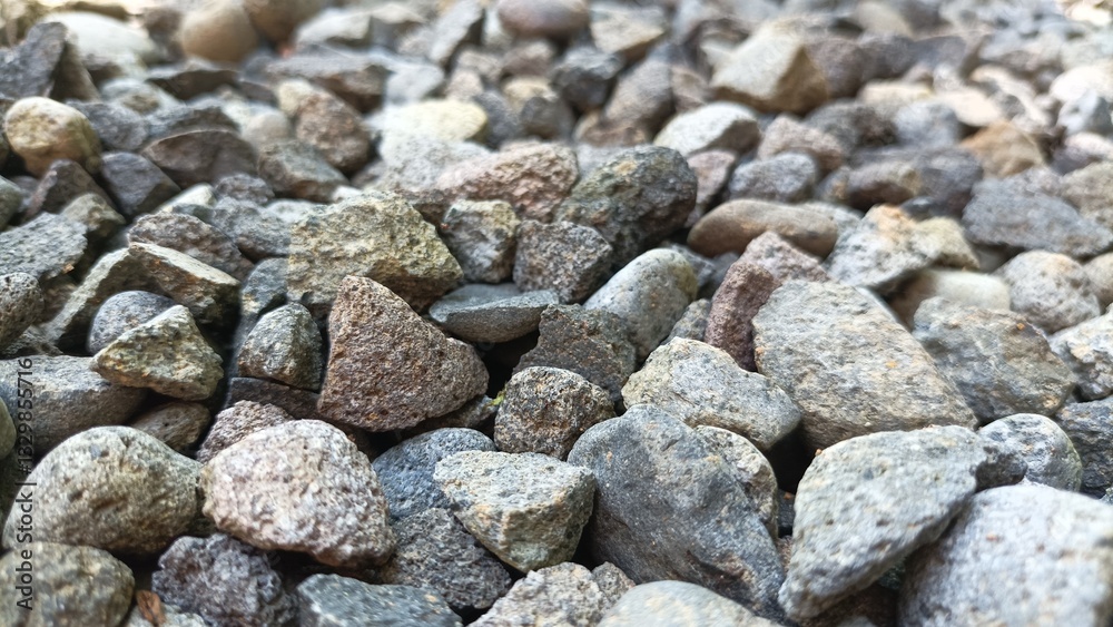 Gray gravel stones for the construction industry. Gravel stones near the railway track. Texture. Background Gray gravel stones for the construction industry. Gravel stones near the railway track. Texture. Background