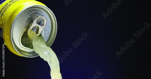A soda can that is full and overflowing with fizzy liquid and vibrant bubbles inside it