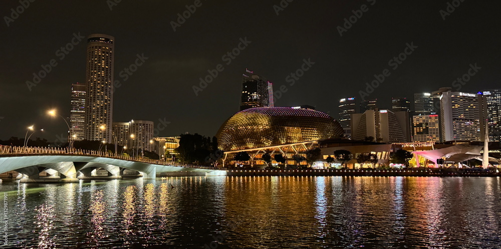 Beautiful lights at night from the buildings with reflection at the bay in Singapore
