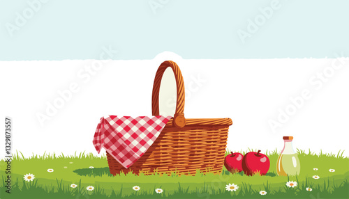 Wicker picnic basket with apples and lemonade in grassy field, summer fun