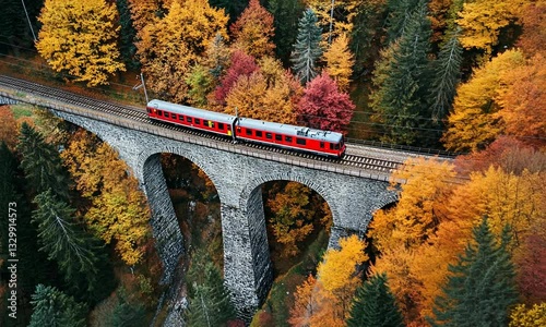 Scenic autumn train journey over a historic stone viaduct surrounded by vibrant foliage