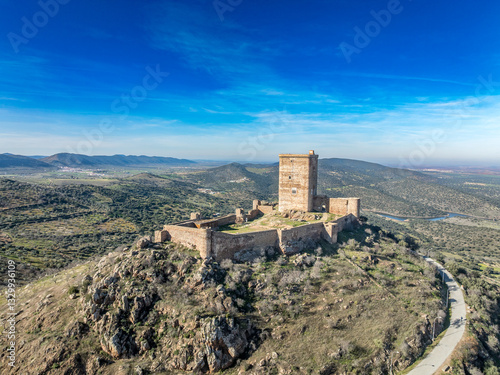 Obraz na płótnie Aerial view of Feria castle in Spain, Gothic and Mudéjar style buildings, square keep, blue sky background w salonie