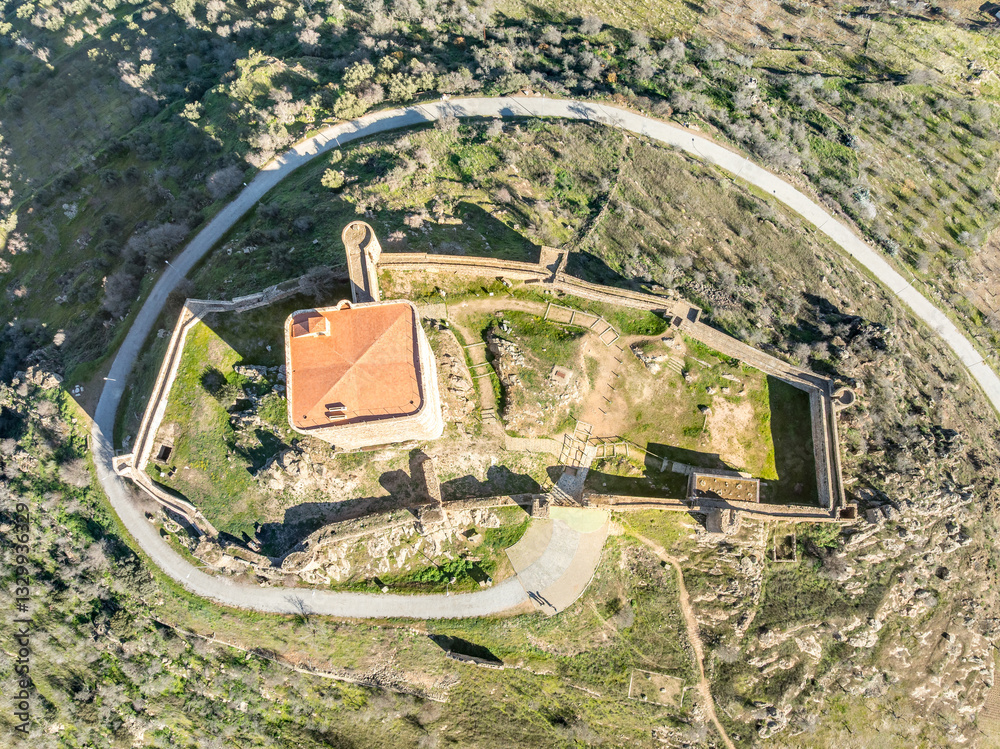Aerial ground plan view of Feria castle in Spain, Gothic and Mudéjar style buildings, square keep, blue sky background