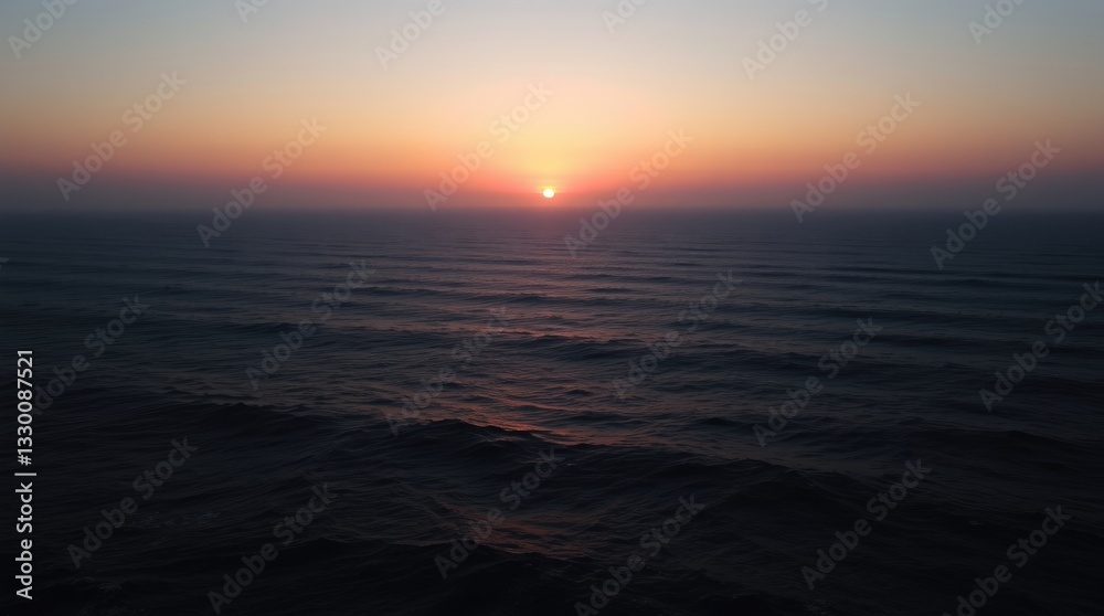 Obraz premium Ocean Sunset Scene with Gentle Waves and Warm Light Glow