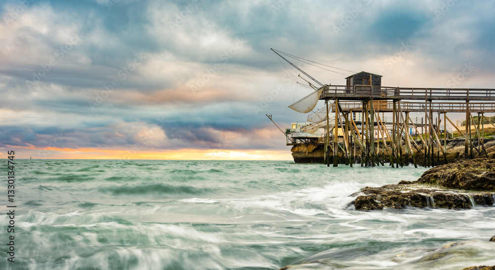 Traditional fisherman hut on stilts with carrelet fishing net on the coast of France. Typical wooden houses for fishing at beach Traditional fisherman hut on stilts with carrelet fishing net on the coast of France. Typical wooden houses for fishing at beach