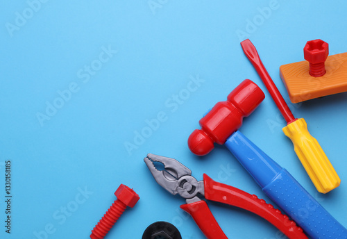 Set of children's toy tools on a blue background. Flat lay