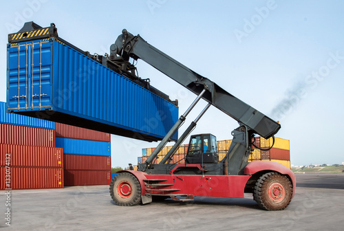 A crane is lifting a container from a ship
