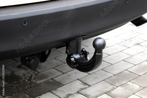 Close up towbar on car. Tow bar of passenger car. Car hook for trailer. Black SUV tow hitch. Trailer hitch or towbar on black vehicle. Tow hitch for towing a trailer.