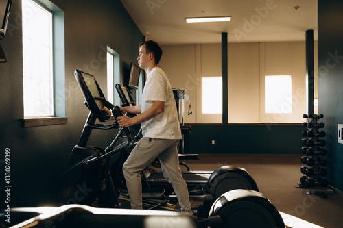 Workout on an elliptical trainer to maintain health and fitness in a specially equipped gym.