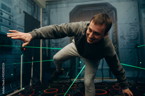The player reaches forward, carefully stepping between the intersecting laser lines. Every move counts.