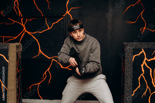 The gray-clad player almost blends in, using the darkness to his advantage. His laser blaster glows, ready to attack.