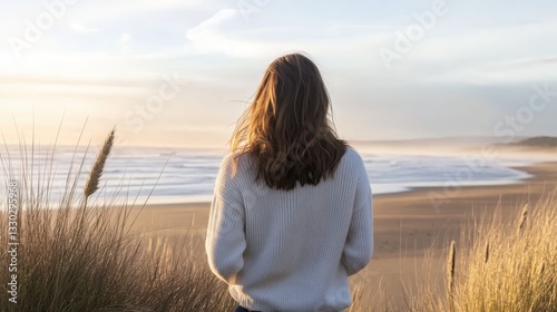 Obraz na płótnie Solitude by the Sea: A Woman Gazes at the Ocean's Horizon w salonie