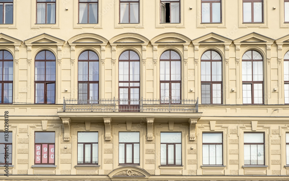 Elegant architecture of historic building in Saint Petersburg showcases intricate window designs and balcony in daylight Elegant architecture of historic building in Saint Petersburg showcases intricate window designs and balcony in daylight