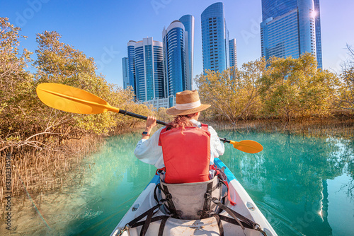 Obraz na płótnie Tourist paddling on a kayak in mangrove Al Reem island mangrove park in Abu Dhabi, United Arab Emirates w salonie