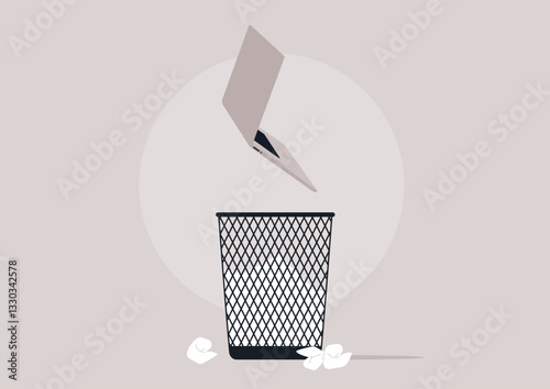 A laptop being tossed into a trash basket, symbolizing the disposal of outdated technology amidst discarded paper
