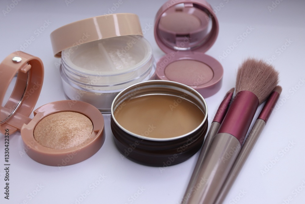Set of decorative cosmetics and makeup brushes on a white background, eye shadow, blush, powder, bronzer, makeup brushes Set of decorative cosmetics and makeup brushes on a white background, eye shadow, blush, powder, bronzer, makeup brushes