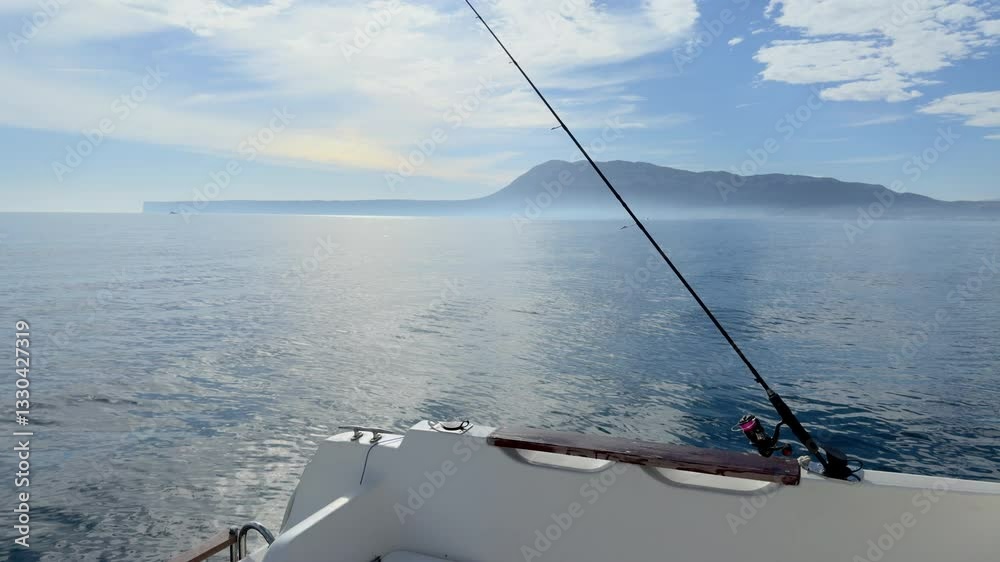 Fishing rod on boat swinging with the waves in Mediterranean sea Fishing rod on boat swinging with the waves in Mediterranean sea