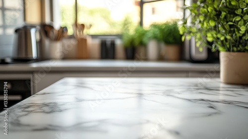 A close-up shows a marble kitchen island.  The background is blurry, showing appliances, utensils, and a plant by a window.
