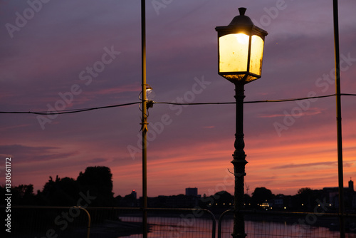 Illuminated Street Lamp at Dusk with Colorful Sky

