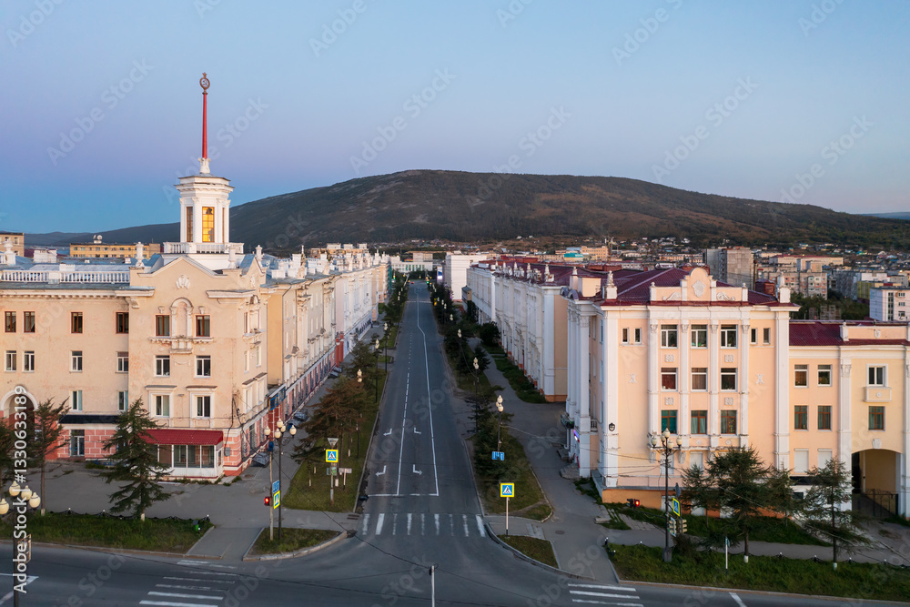 Aerial view of the city of Magadan. Top view of the streets and buildings. Morning cityscape. Building with a tower in the historical center of the city of Magadan. Magadan region, Far East of Russia.