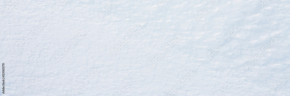 Natural snow texture. Smooth surface of clean fresh snow. Snowy ground. Winter background with snow patterns. Closeup top view. Wide panoramic texture for background and design.