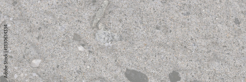Concrete wall texture with pebbles. Decorative rough concrete surface with stones. Wide panoramic texture for background and design.